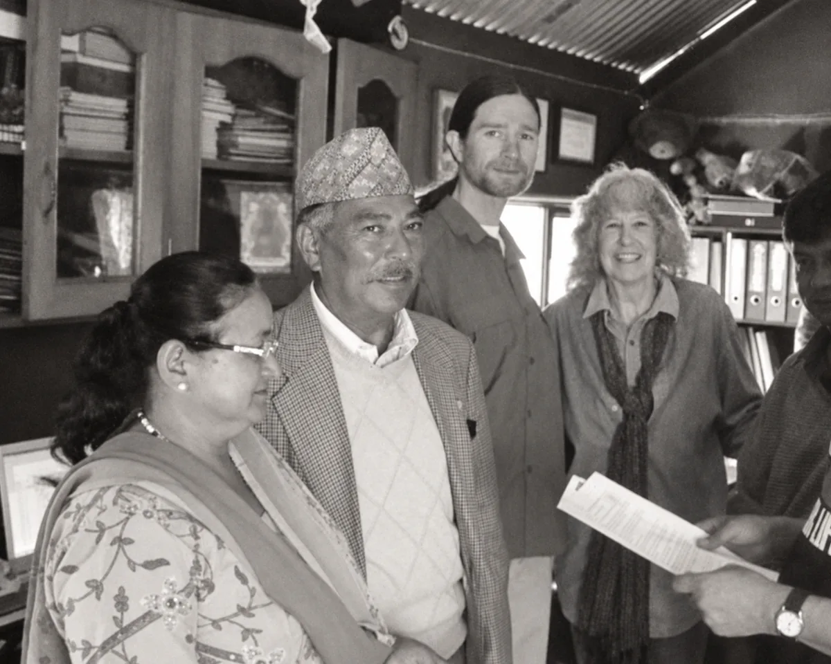The founder with colleagues and visitors in an early Manaram office