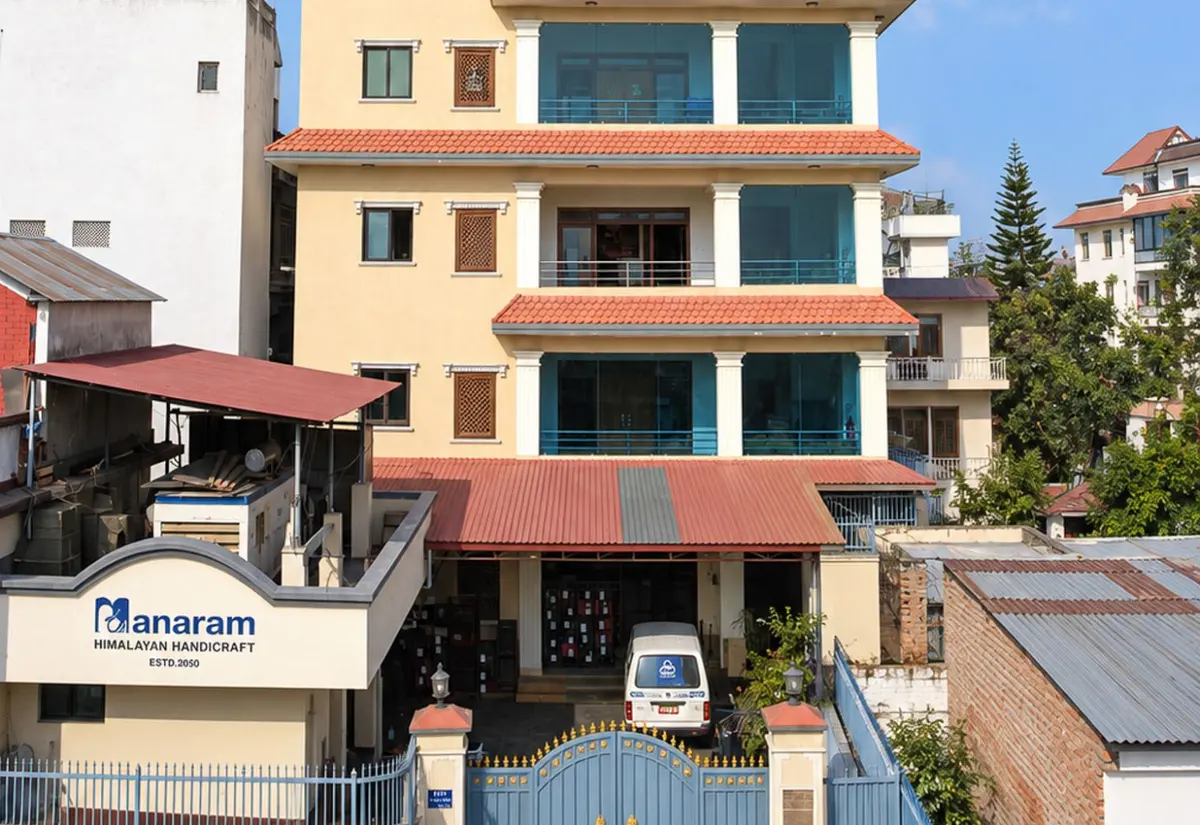 The Manaram Himalayan Handicraft building in Chandol, Kathmandu, with the company sign at the gate