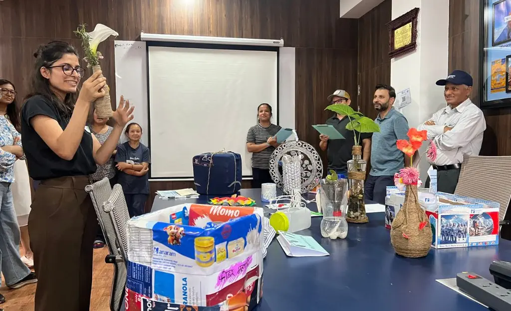 An employee presenting upcycled creations at the 24-hour upcycle challenge